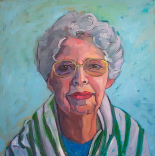 Portrait of a female senior citizen with grey hair and green and white  shirt.