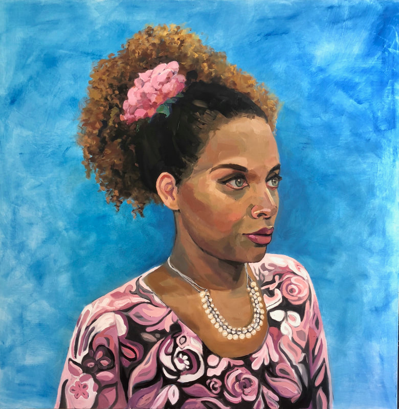 Portrait of a black woman with a flower in her hair and a flowery dress.