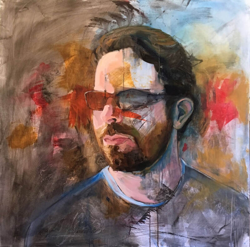 Portrait of a white man in a dark beard and abstract shapes.