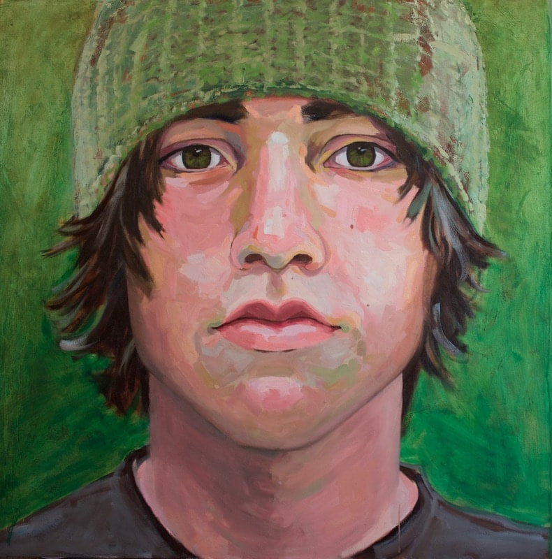 Portrait of a teenage boy with brown hair in a green beanie