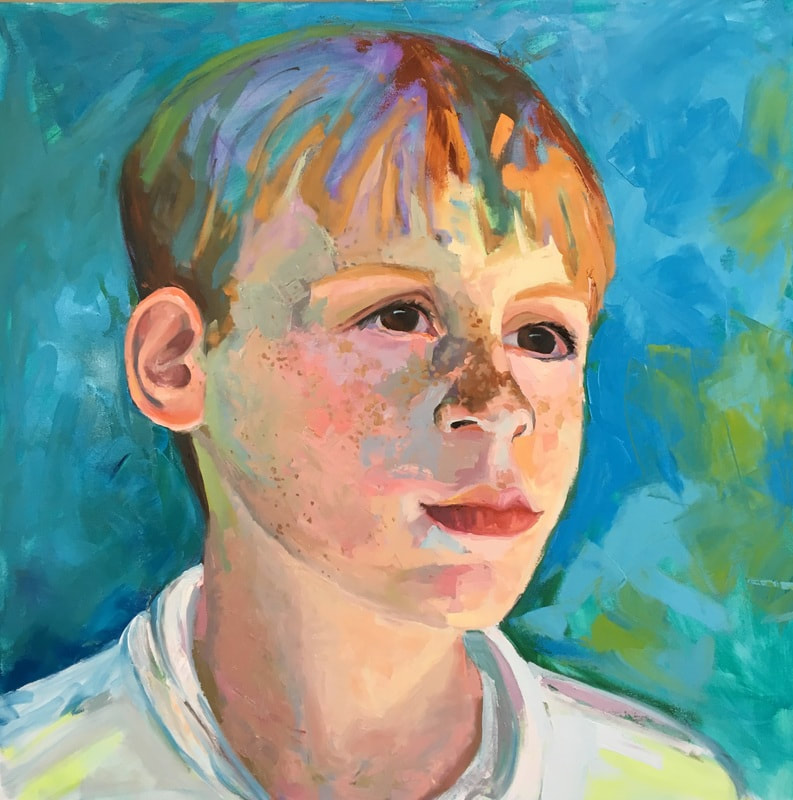 Portrait of a white boy with multi colored hair and freckles.
