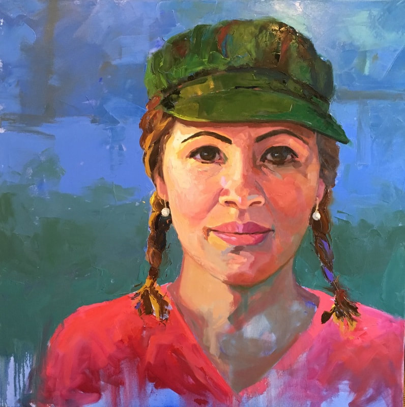 Portrait of a Latina in pink shirt and green cap