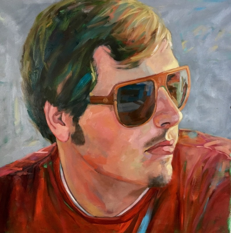Portrait of a white man with sunglasses and a red shirt.
