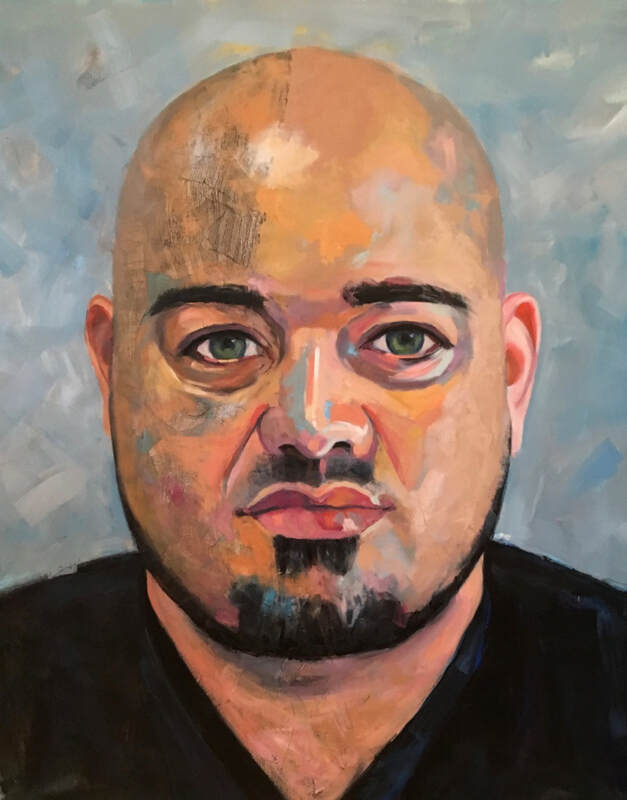 Portrait of a bald Latino man in a black t-shirt