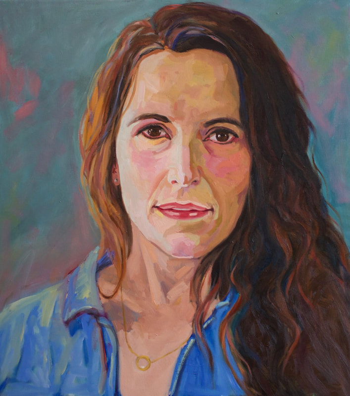 Portrait of a Native American woman in a blue shirt.
